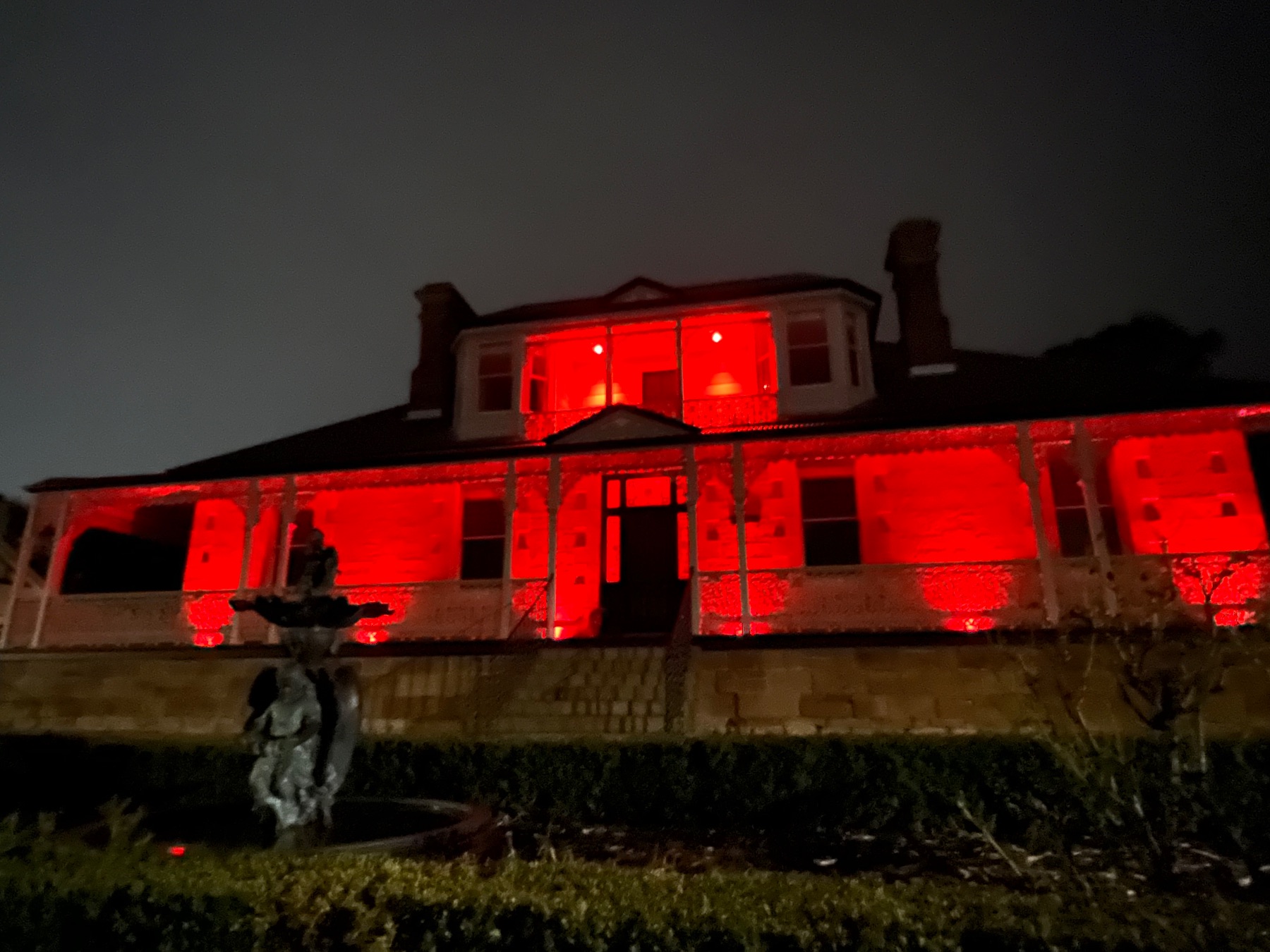 House illuminated with red lights. 