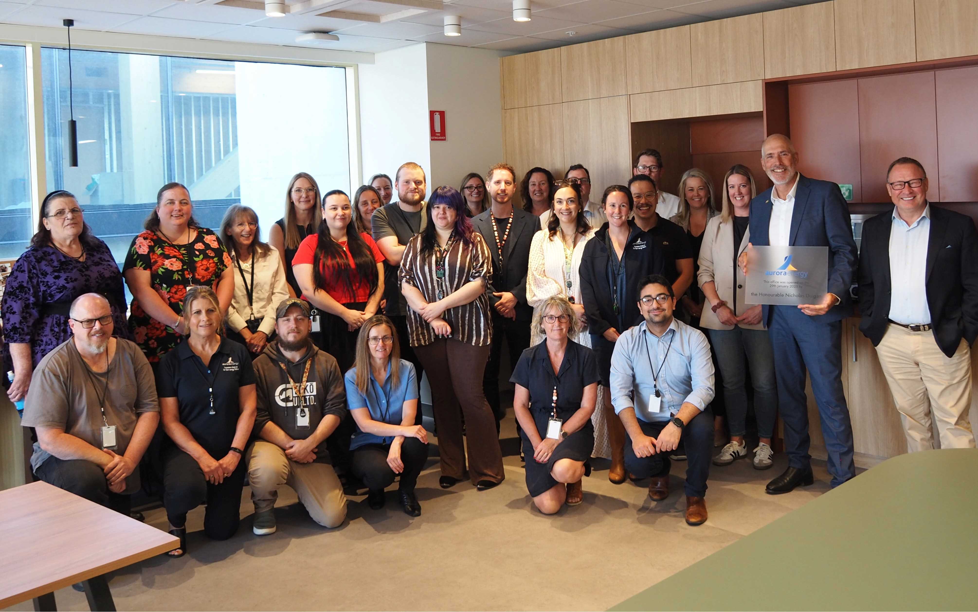 Aurora CEO Nigel Clark and Minister Nick Duigan with Launceston employees in the new office 